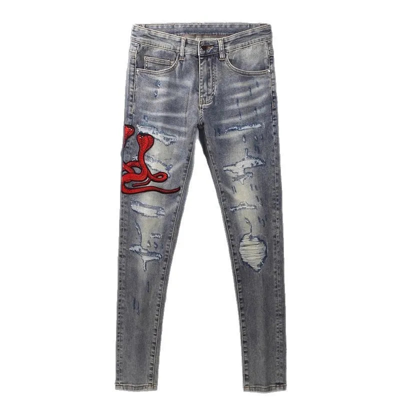 Men's slim fit jeans in a washed-out old colour with distressed hole and patch details on the legs.
