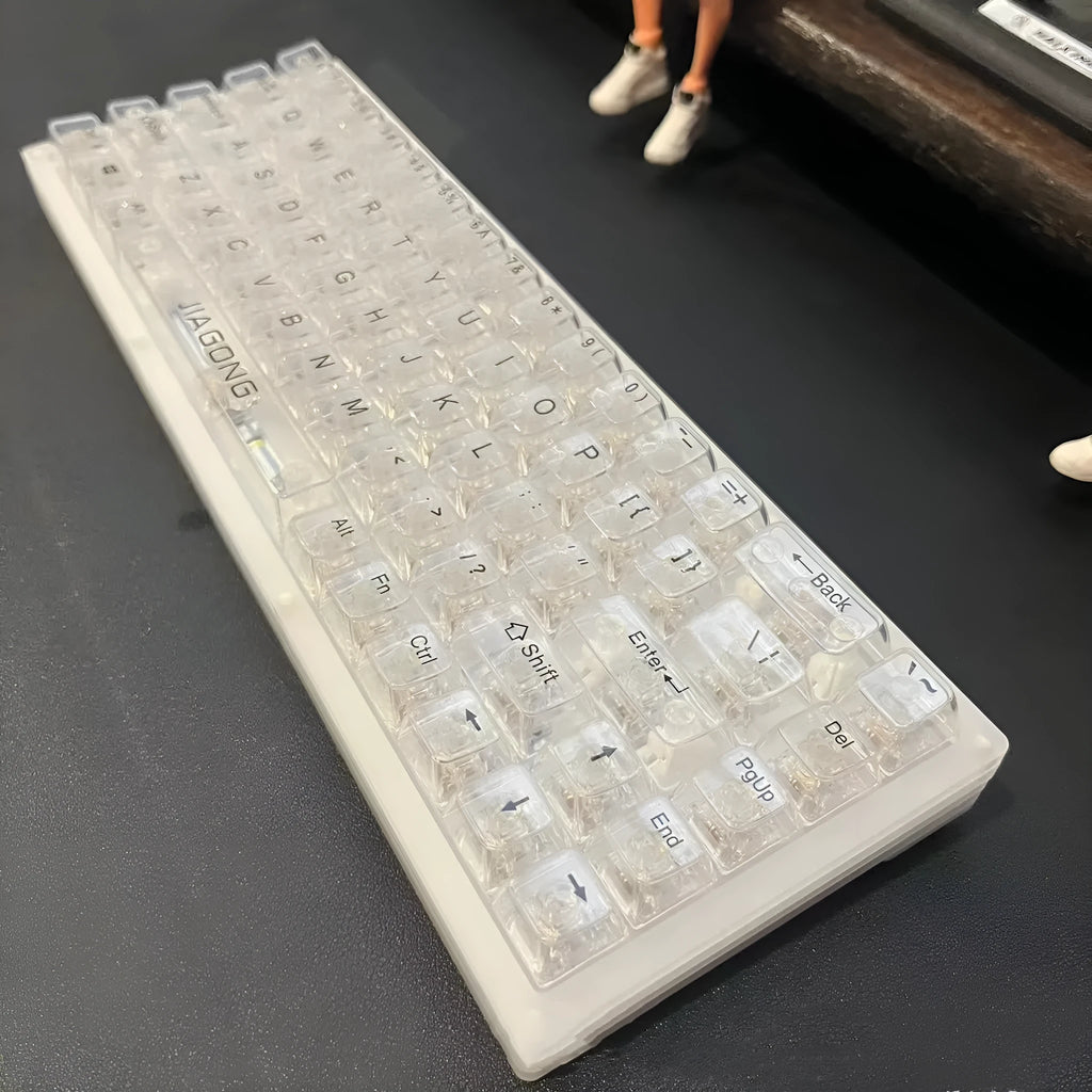 132 transparent plastic mechanical keyboard key caps laid out in grid pattern