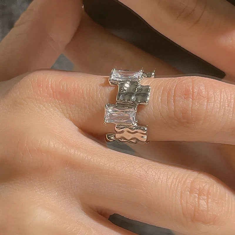 Silver geometric cross ring with zircon detailing and open gemstone setting
