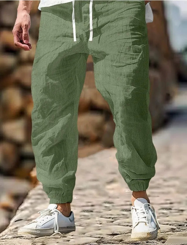 Men's straight-cut linen trousers with elastic waist in army green colour showing cotton fabric composition