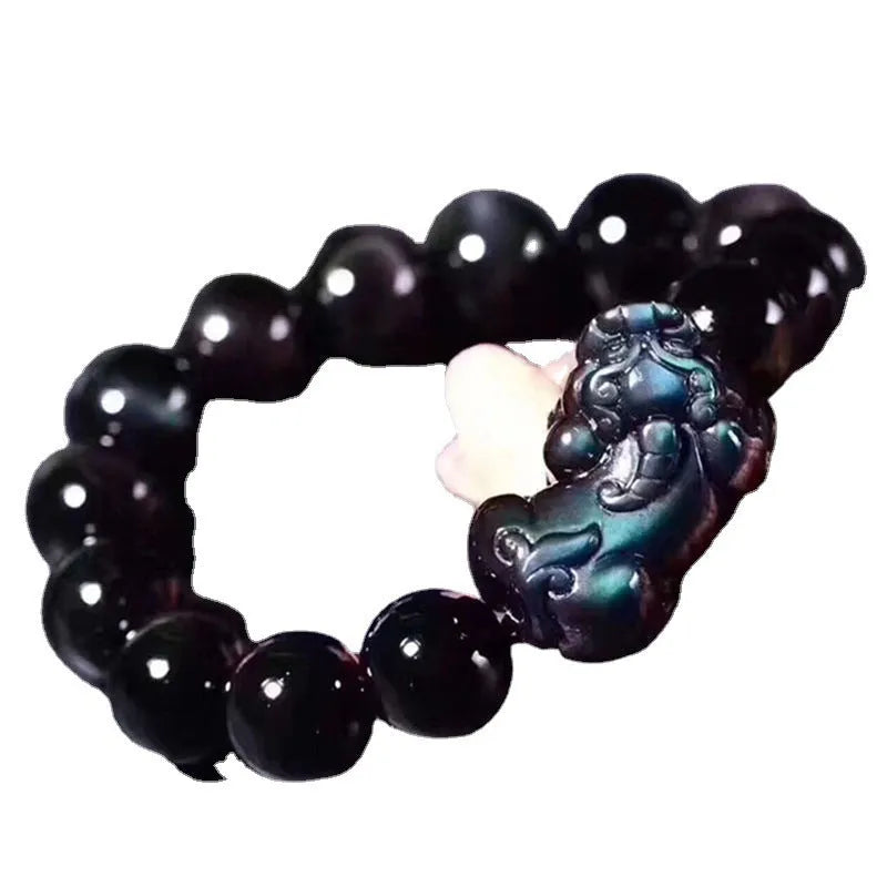 Natural ice colour obsidian crystal bracelet with spherical beads on a wrist.