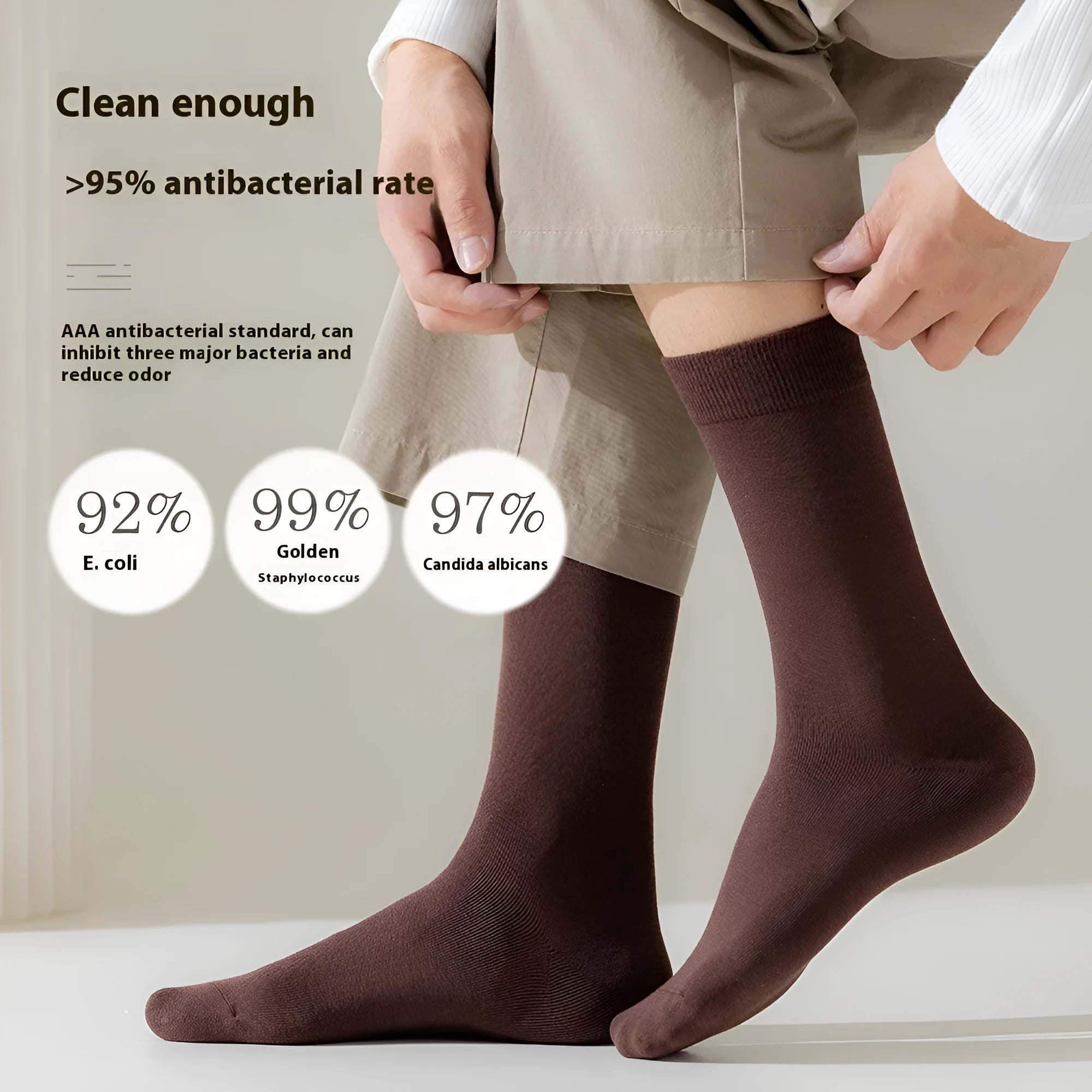 A pair of men's solid colour mid-calf socks made from combed cotton, shown in a light grey hue.