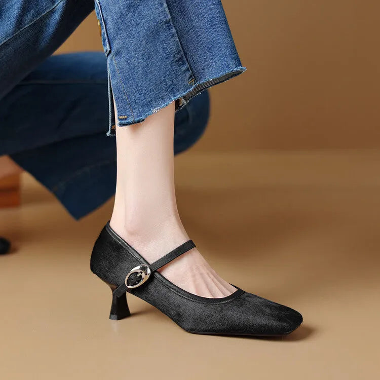 Women's black square toe stiletto heel ankle-strap shoes with horse hair upper on a neutral background.