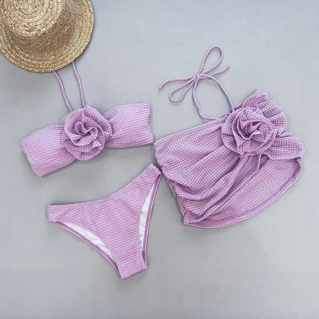 Women's purple and white 3D flower split swimsuit bikini three-piece set on a mannequin.