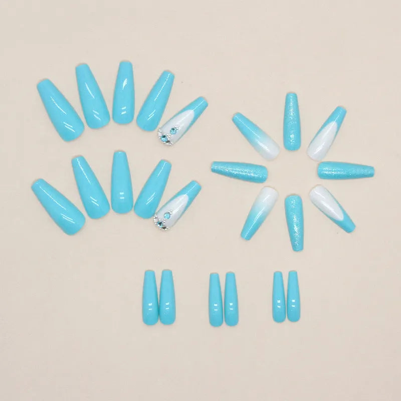 Long ballet artificial nails in smart blue diamond colour with glitter debris particles