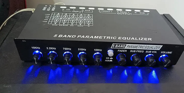 Black car audio EQ amplifier unit with control knobs, showing rear RCA input and output connections.