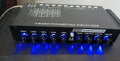 Black car audio EQ amplifier unit with control knobs, showing rear RCA input and output connections.