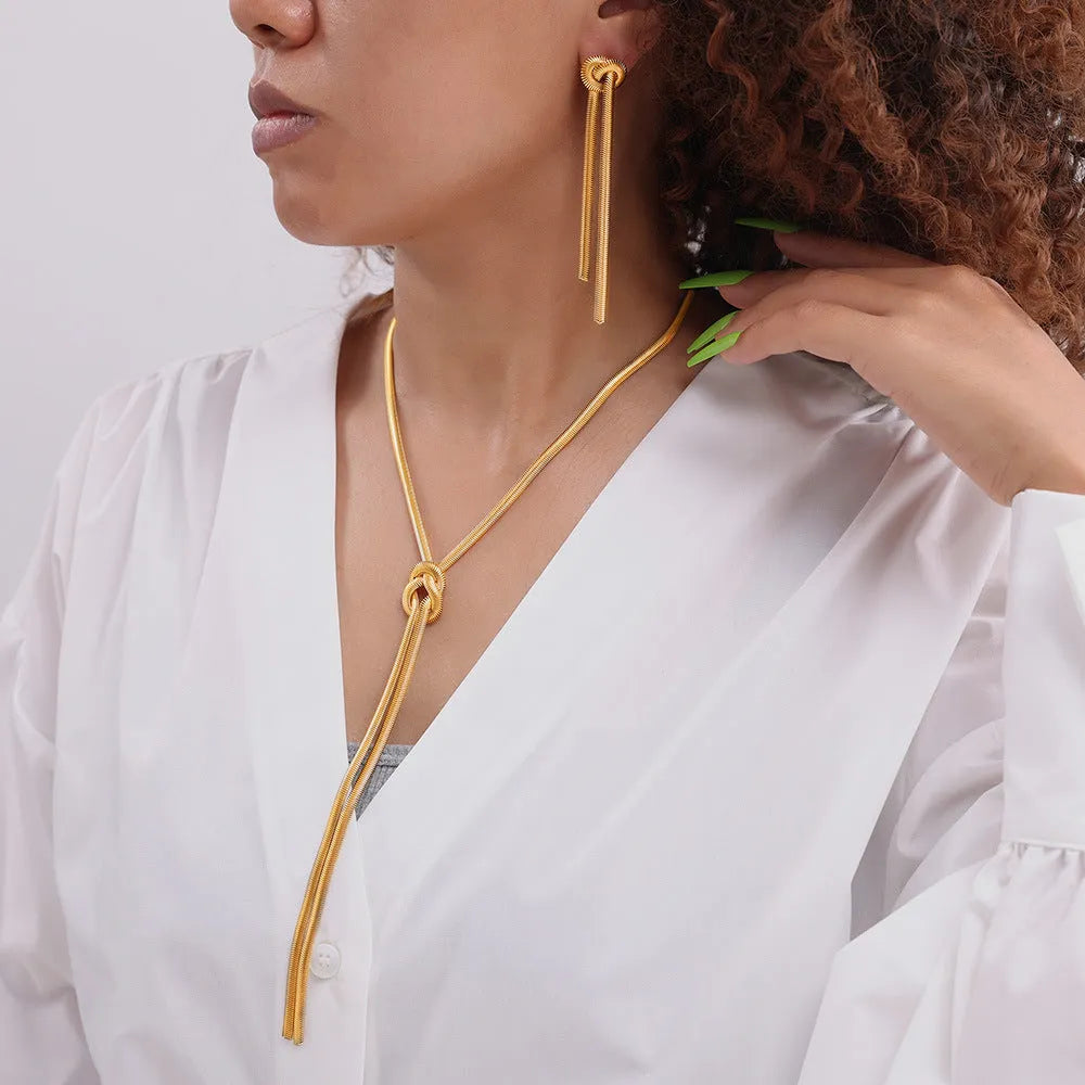 Gold knotted tassel pendant on titanium steel snake chain necklace with matching earrings
