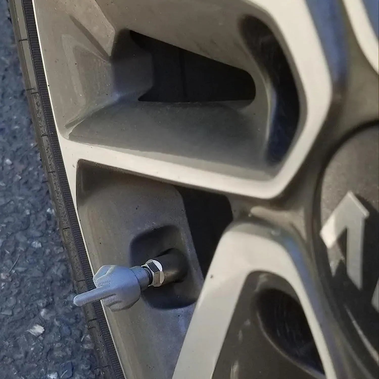 Eight latex car tyre valve caps showing black and skin colour pieces for tyre pressure maintenance