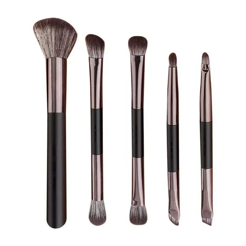 Makeup brush set with mirror showing artificial fibre bristles and plastic handles in portable packaging