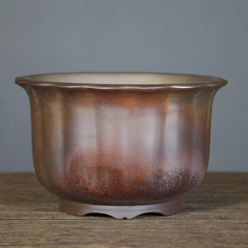 Antique carved ceramic flower pot with purple sand finish and wood burning texture