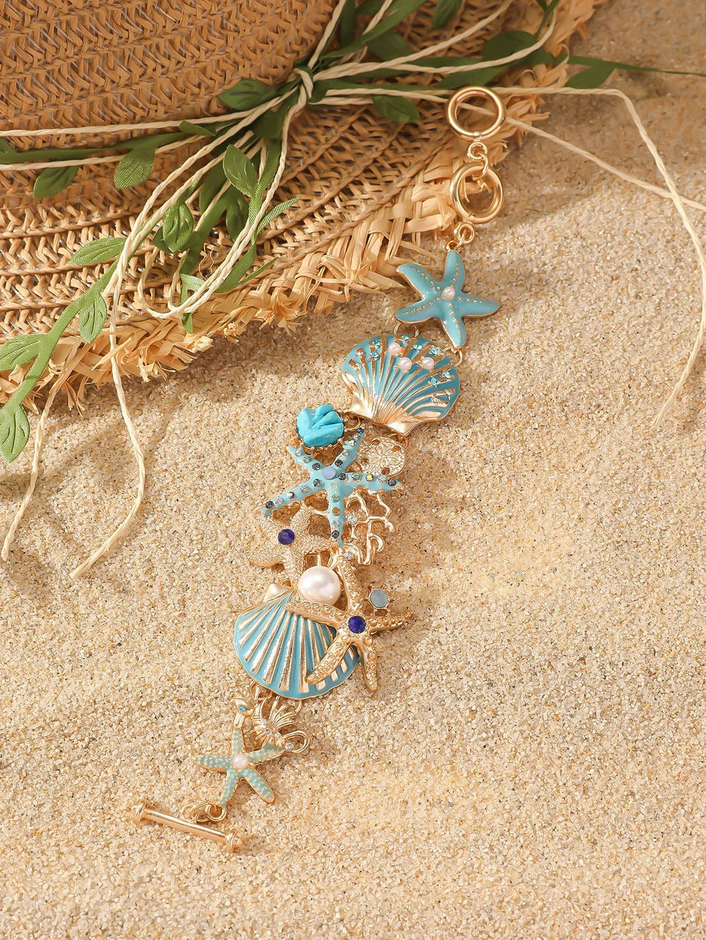 Close-up of a women's alloy starfish rhinestone bracelet in turquoise colour.