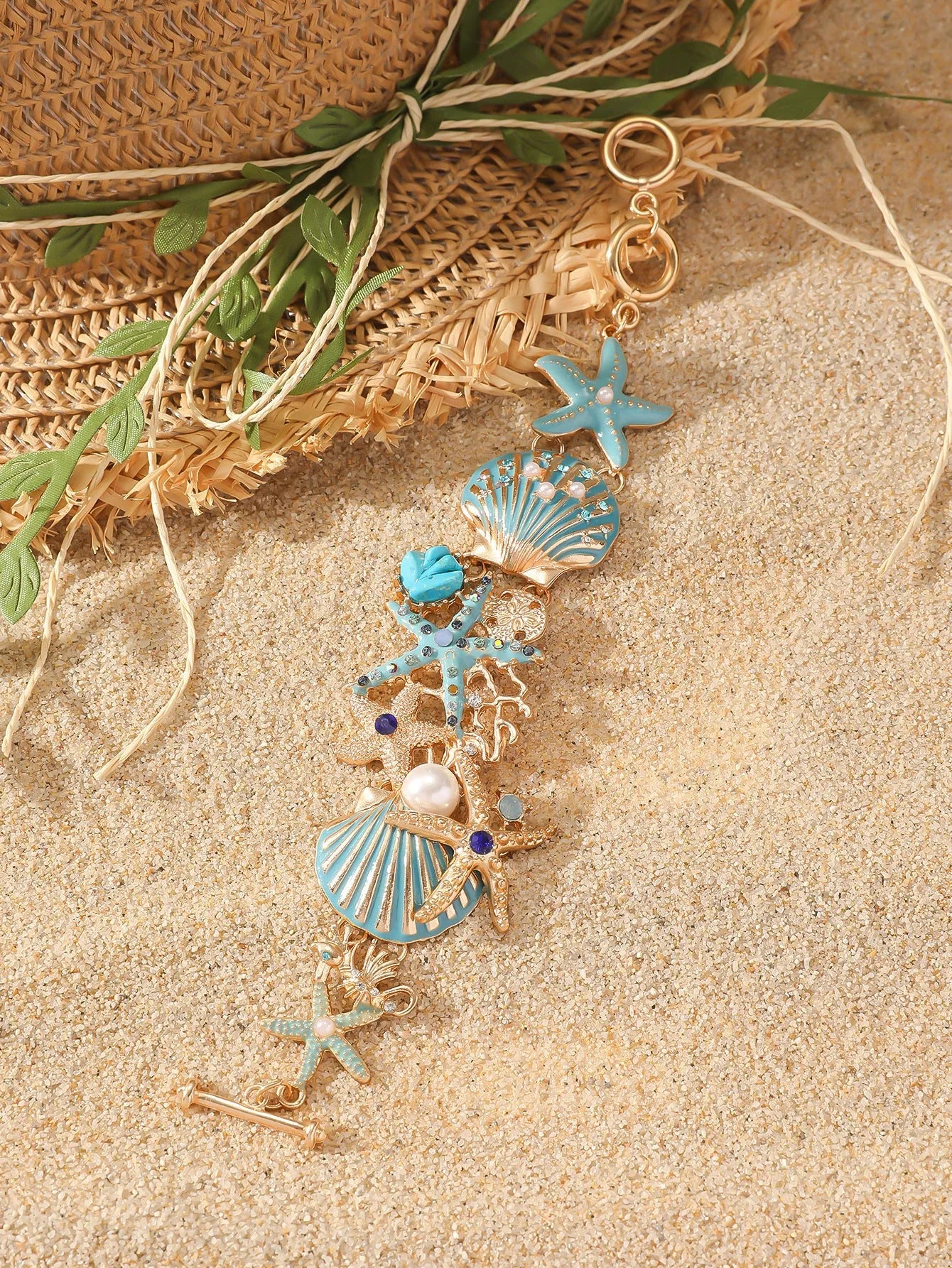 Close-up of a women's alloy starfish rhinestone bracelet in turquoise colour.