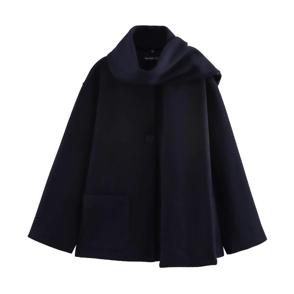 Women's long black polyester overcoat with a gray artificial fur collar, showing street fashion style and front pockets.