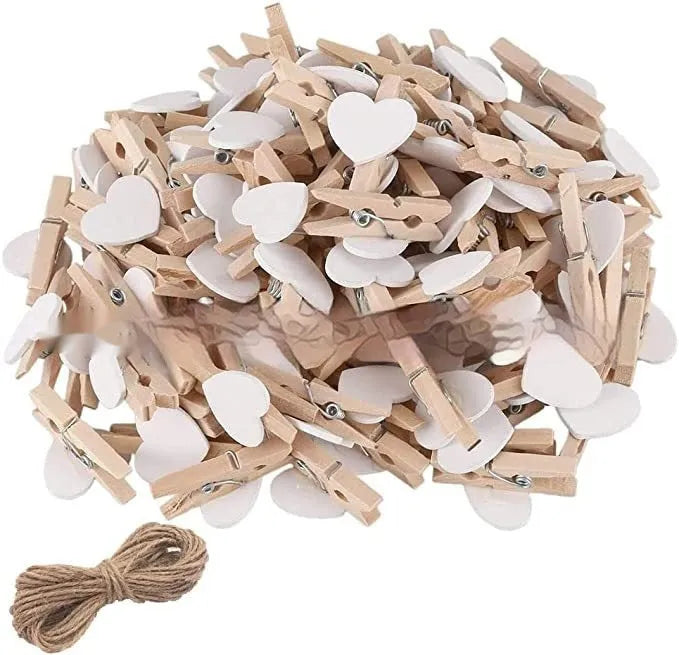 Five solid wood heart-shaped clips in red, rose red, and white colours on a natural background.