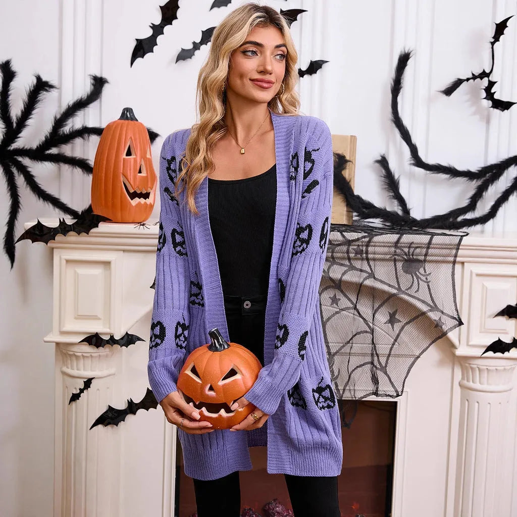 Women's black Halloween cardigan with orange pumpkin head jacquard pattern, shown as a straight-cut medium-length knit.