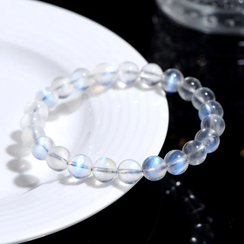 Natural cream body blue moonlight crystal bracelet on a wrist, showing single circle format.