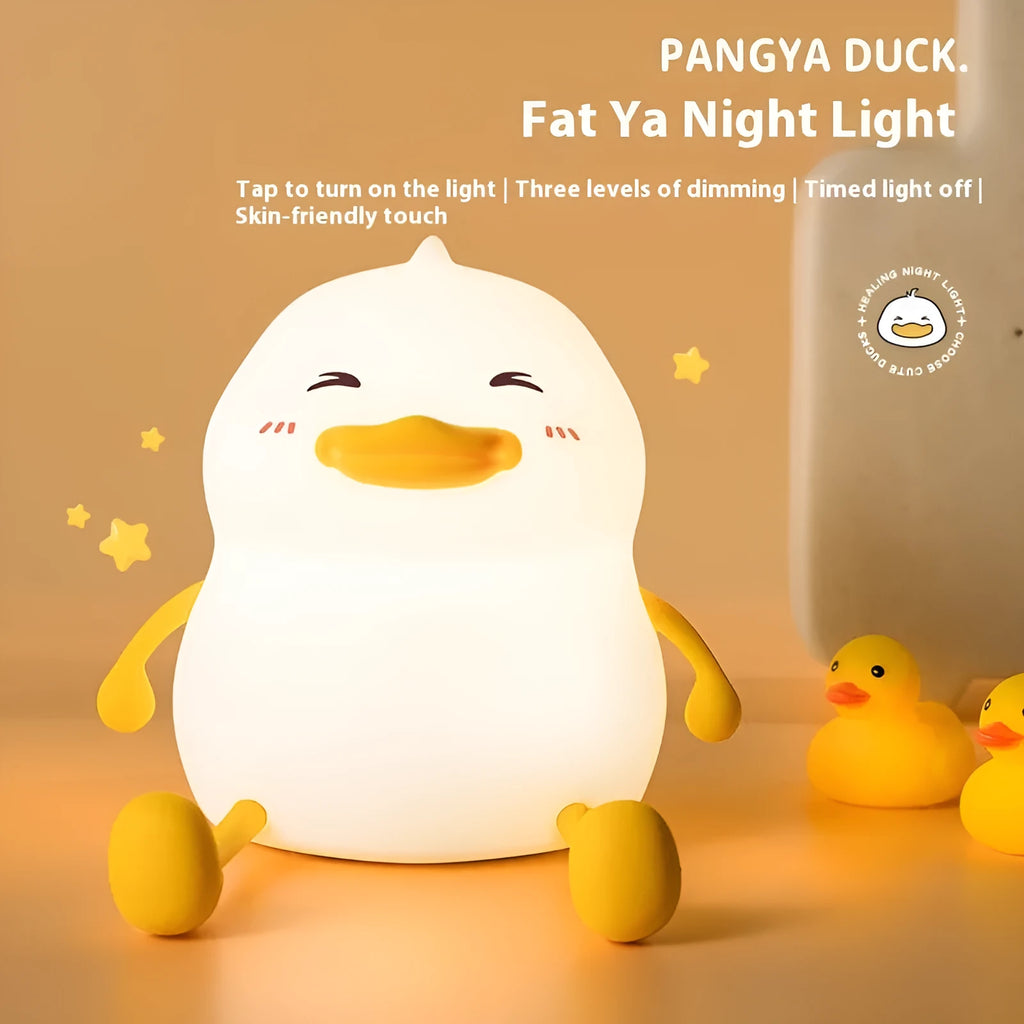 Chubby rechargeable touch-control night light with soft silicone phone holder base.