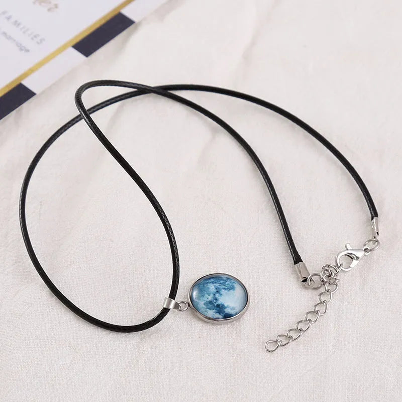 Close-up of a luminous constellation model glass pendant on an alloy necklace chain with extension.