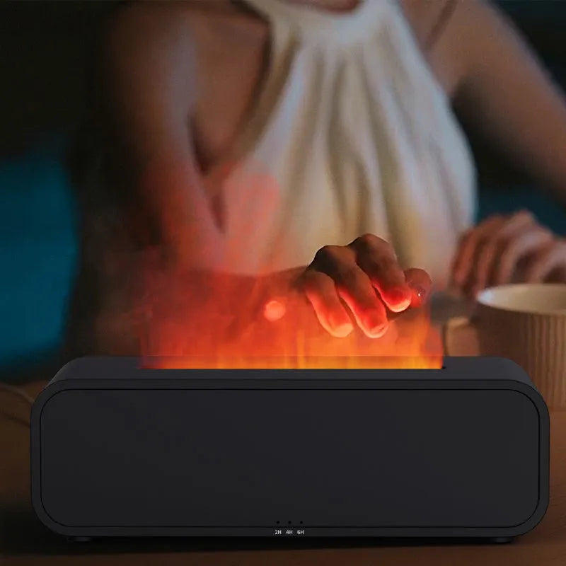 Black Flame Dynamic essential oil aroma diffuser with remote control on a wooden table, showing colour-changing LED lights.