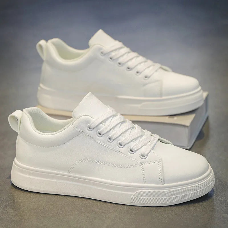 Men's low-top casual sneakers in white, black, or black with white sole, showing round toe and flat rubber sole.