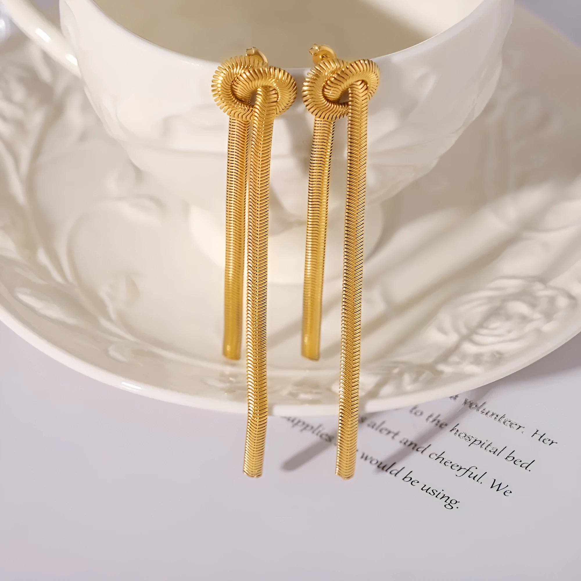 Gold knotted tassel pendant on titanium steel snake chain necklace with matching earrings