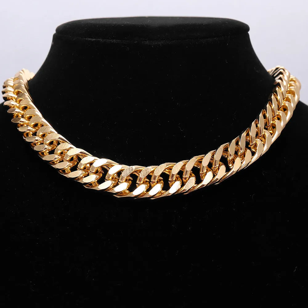 Gold women's thick chain necklace with 32cm length on a plain background.