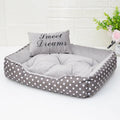Polka dot print square dog bed with a matching embroidered pillow in grey, blue, pink, or red.