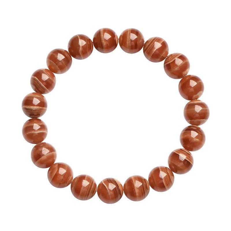 Natural old mine rhodochrosite round bead bracelet with Ruyi symbol on a wrist.