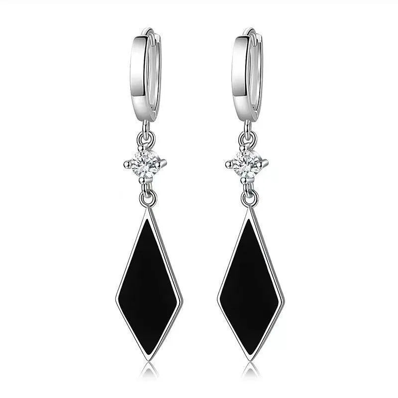 Silver vintage geometric diamond-shaped clip-on earrings on a plain background.