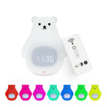 White bear-shaped silicone night light with remote control on a table.