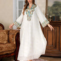White long Arabic robe dress for women with long sleeves on a hanger