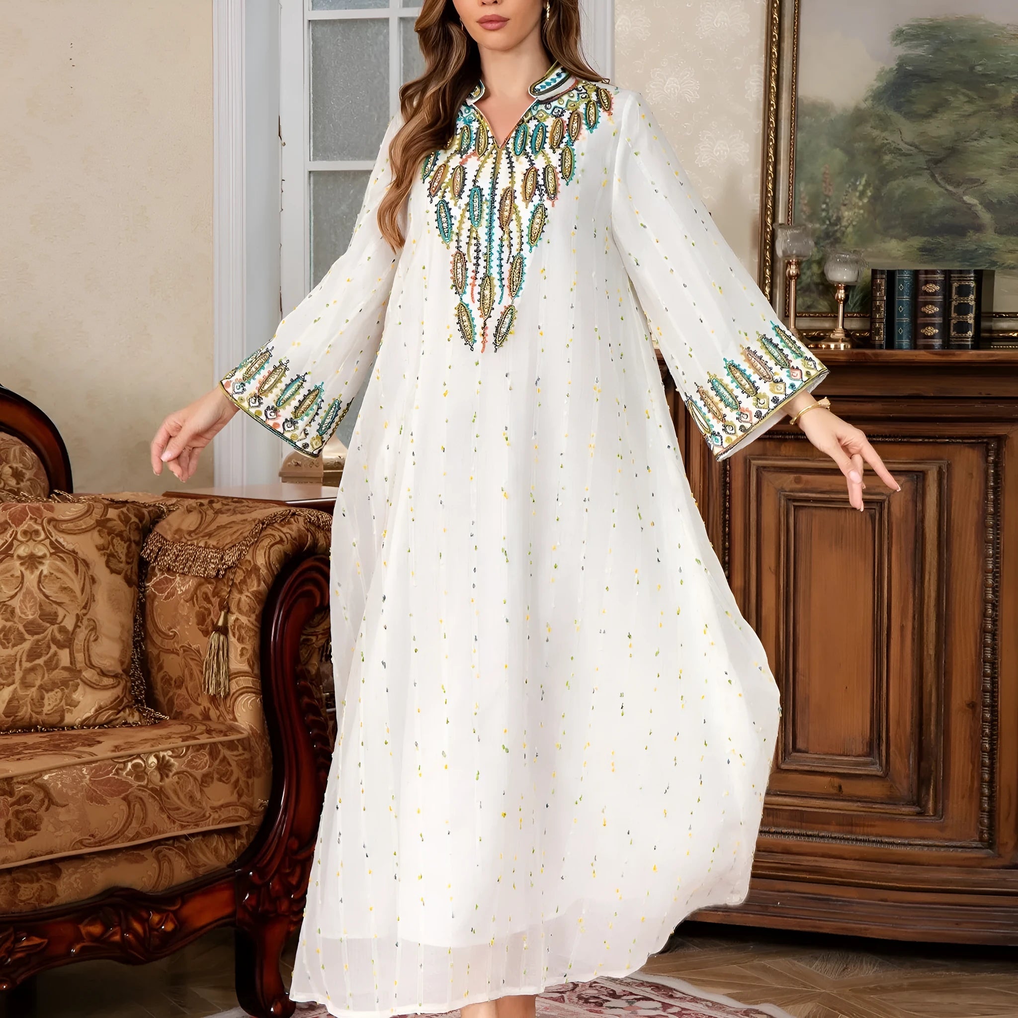 White long Arabic robe dress for women with long sleeves on a hanger