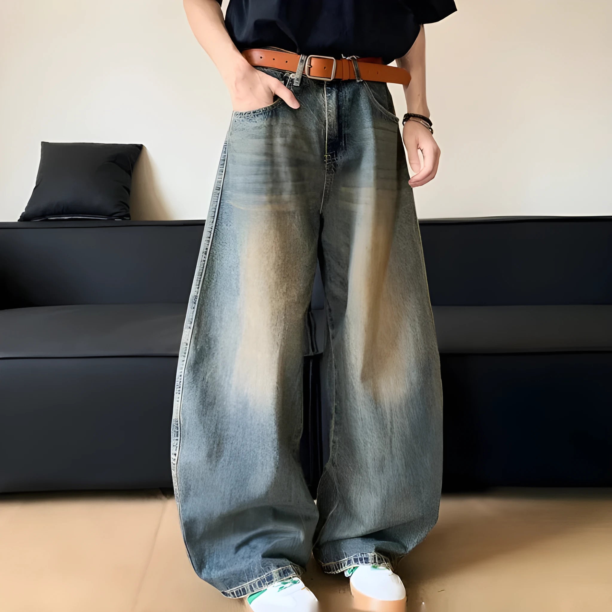 Man wearing retro blue distressed wide-leg denim jeans with a slimming fit and mid waist design.