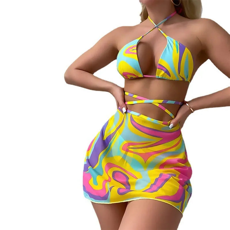 Yellow striped women's halter swimsuit with lace-up front, shown with matching high-waisted skirt and shorts.