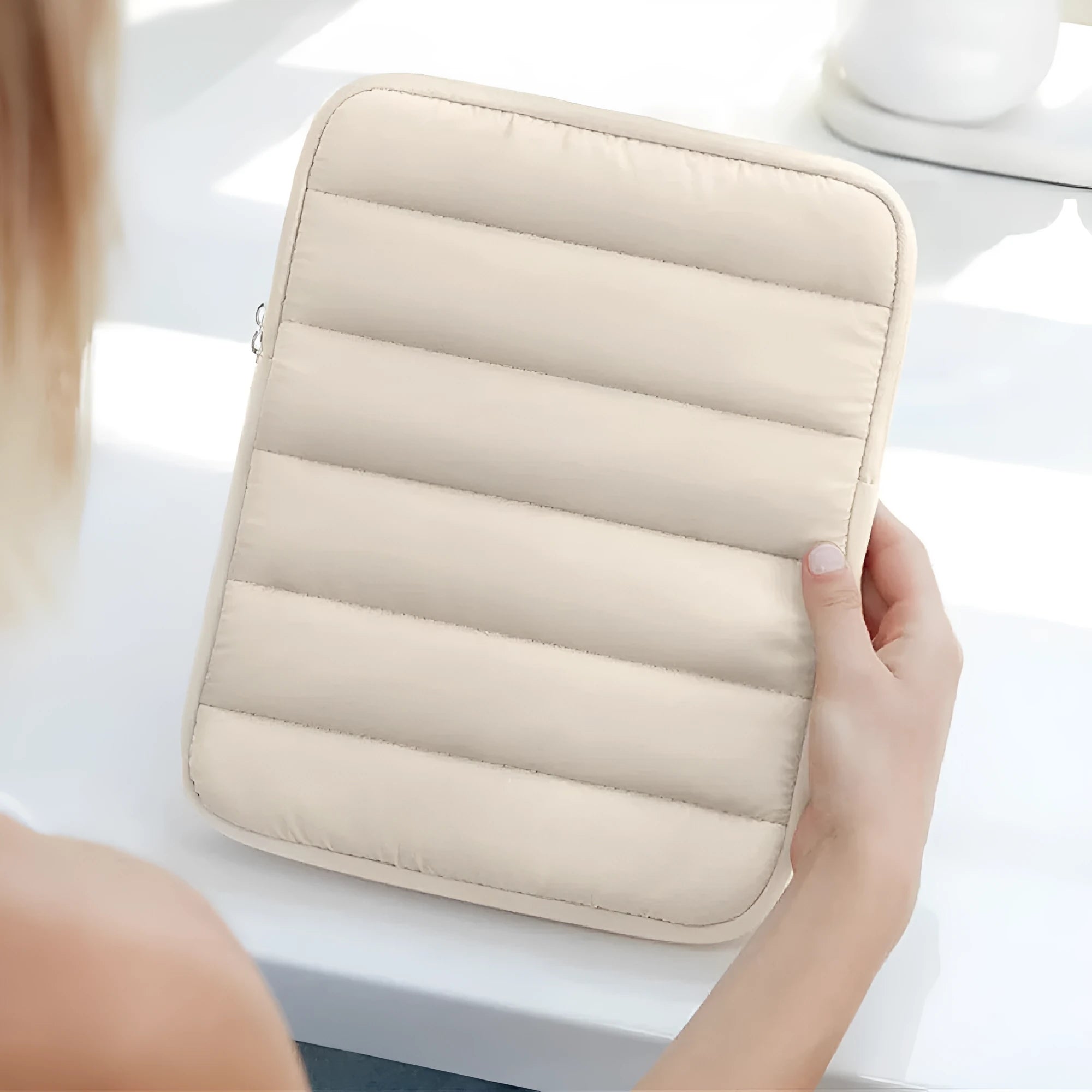 Fluffy air feeling laptop sleeve puff bag in black, shown with elastic sides, for 9.7 to 11 inch devices.