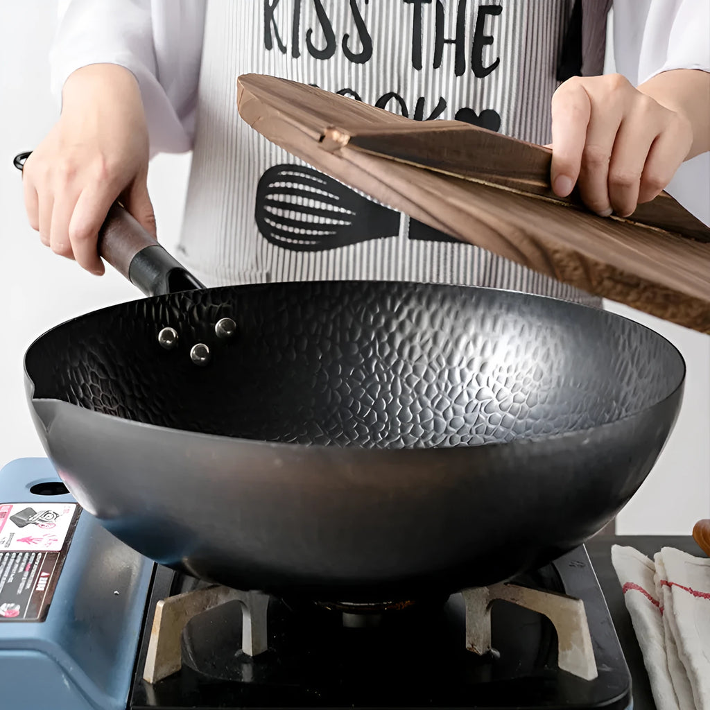 Black traditional iron wok with wooden handle measuring 40cm diameter