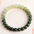 Natural Hetian jade bracelet with water gradient colouring showing polished stones in casual unisex design