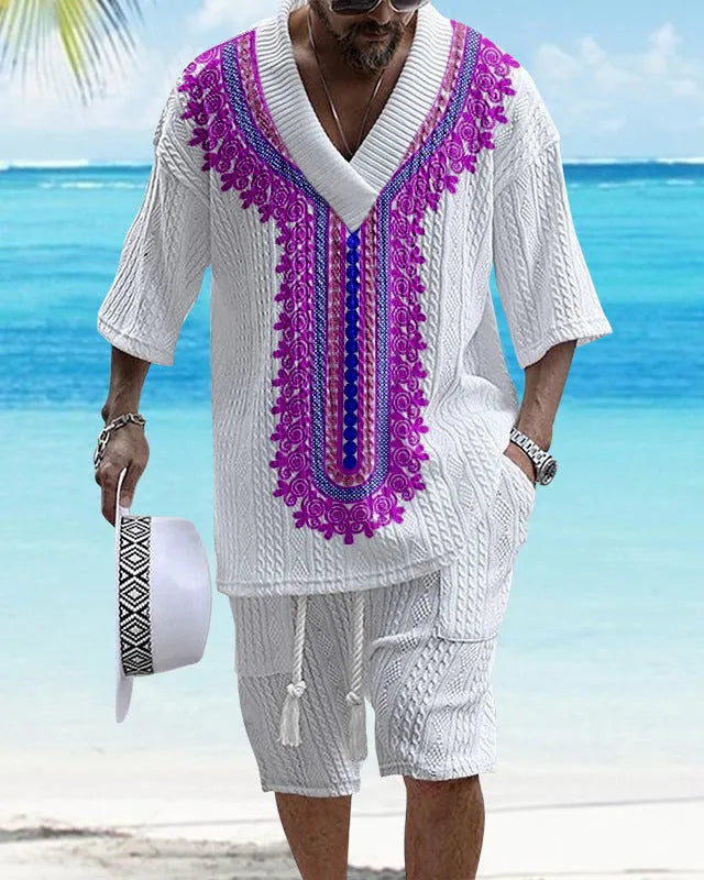 Man wearing a printed drop-shoulder short-sleeved knitted top with matching shorts in a blue colour.