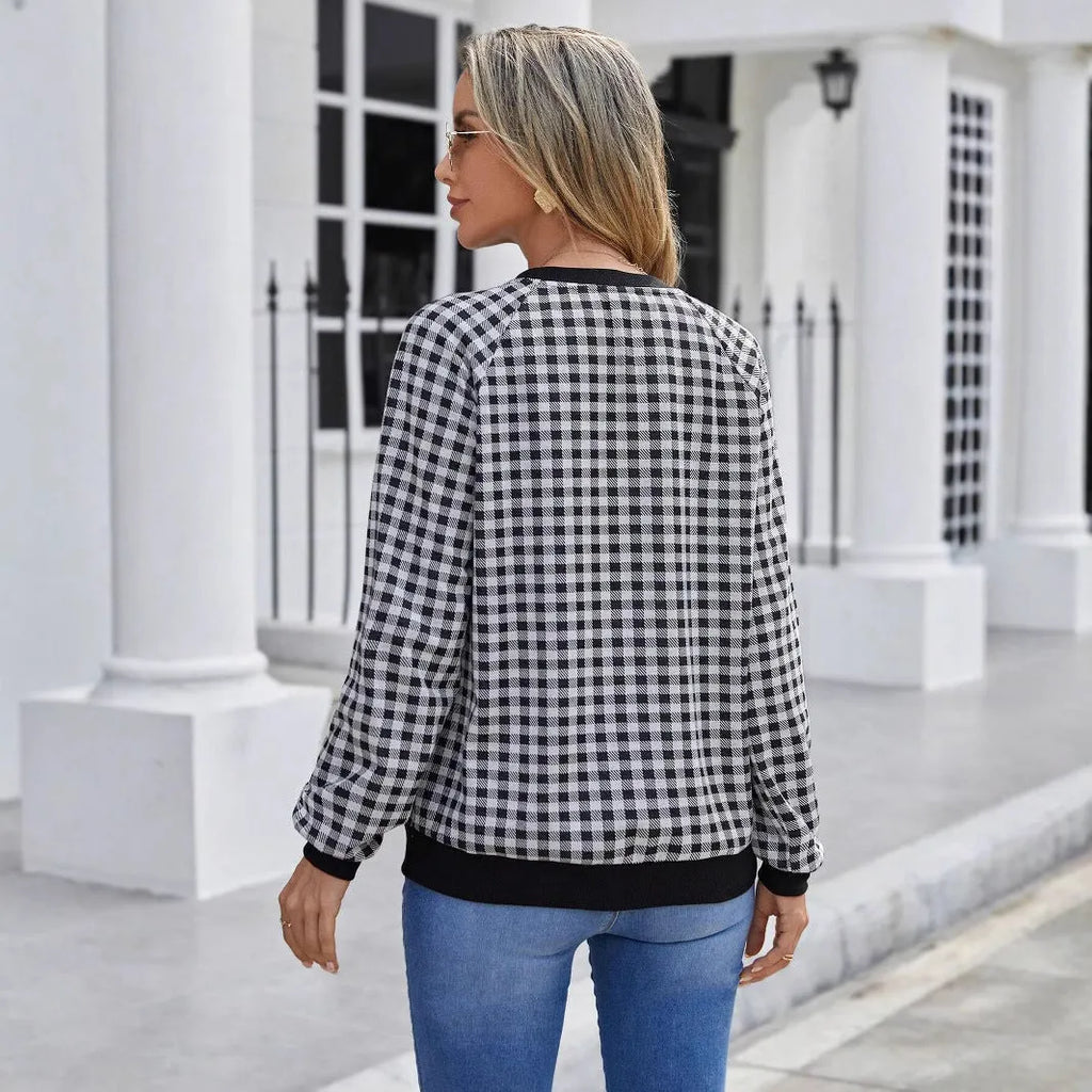 Black Japanese plaid pattern long sleeve pullover sweater on a hanger.