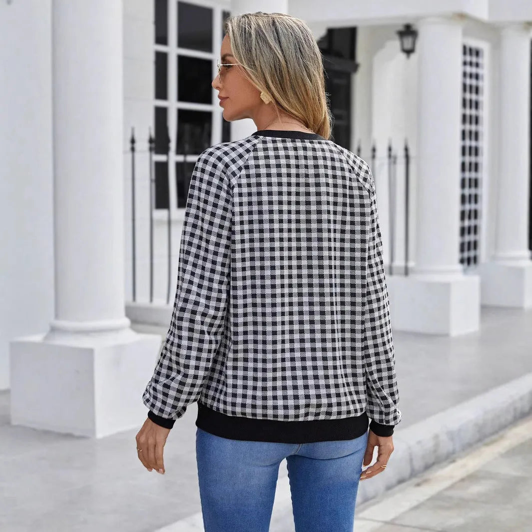 Black Japanese plaid pattern long sleeve pullover sweater on a hanger.