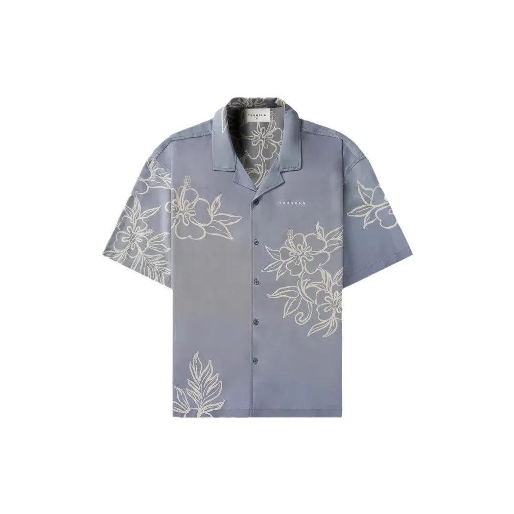 A man's loose-fitting, short-sleeve casual top with a floral print, shown in a neutral colour.