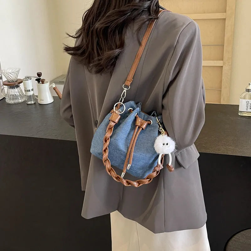 Blue one-shoulder cross body bucket bag with synthetic leather lining and medium-soft construction
