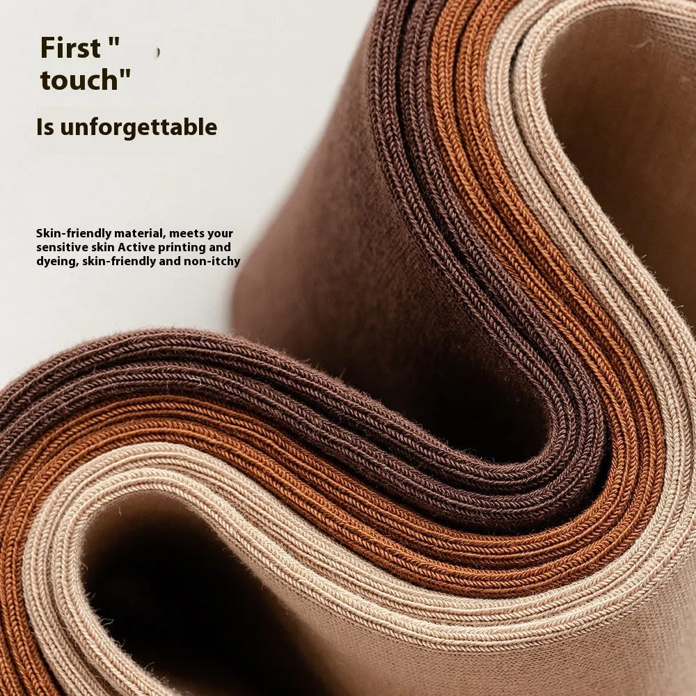A pair of men's solid colour mid-calf socks made from combed cotton, shown in a light grey hue.