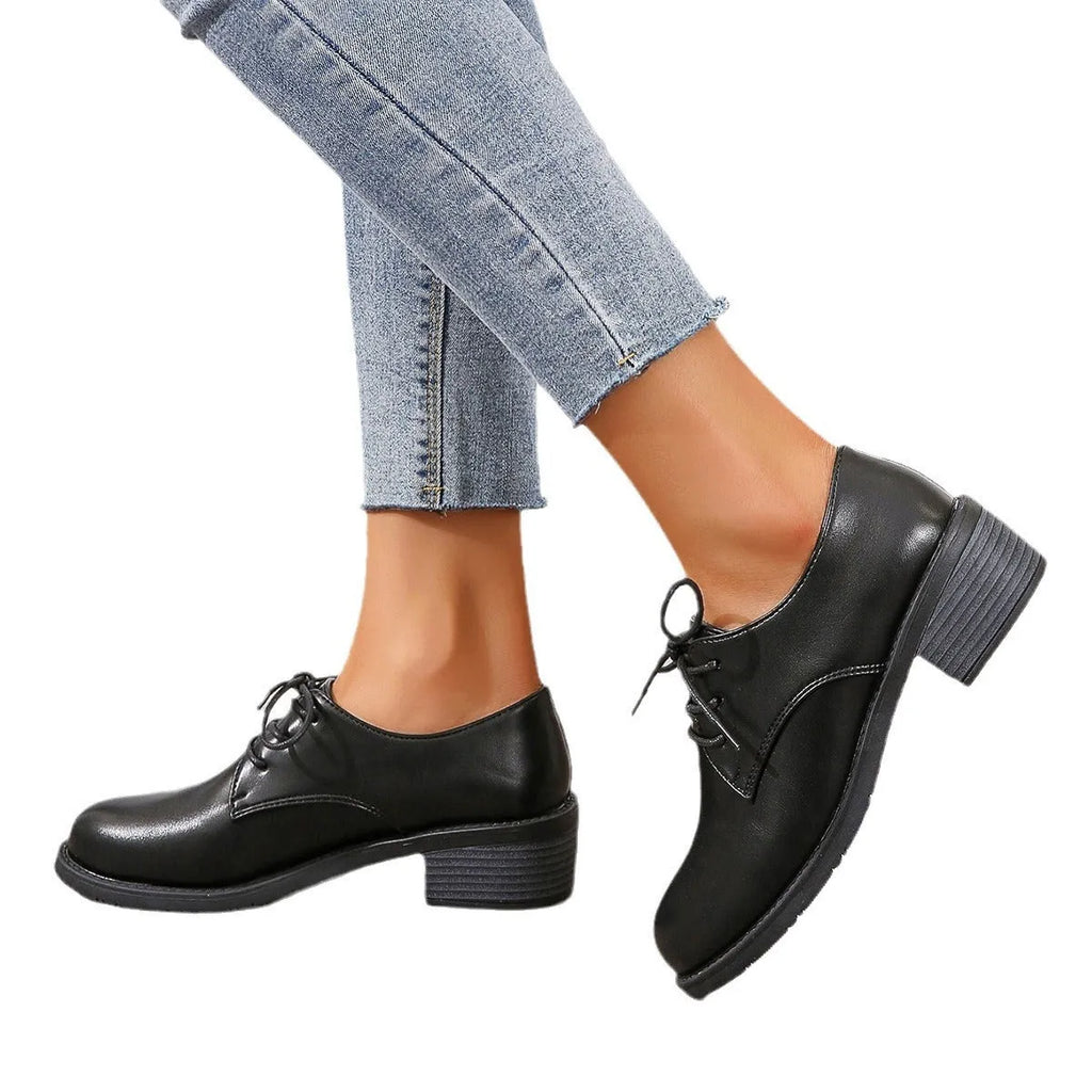 Black women's low-top work shoes with a thick chunky rubber heel and a PU leather upper