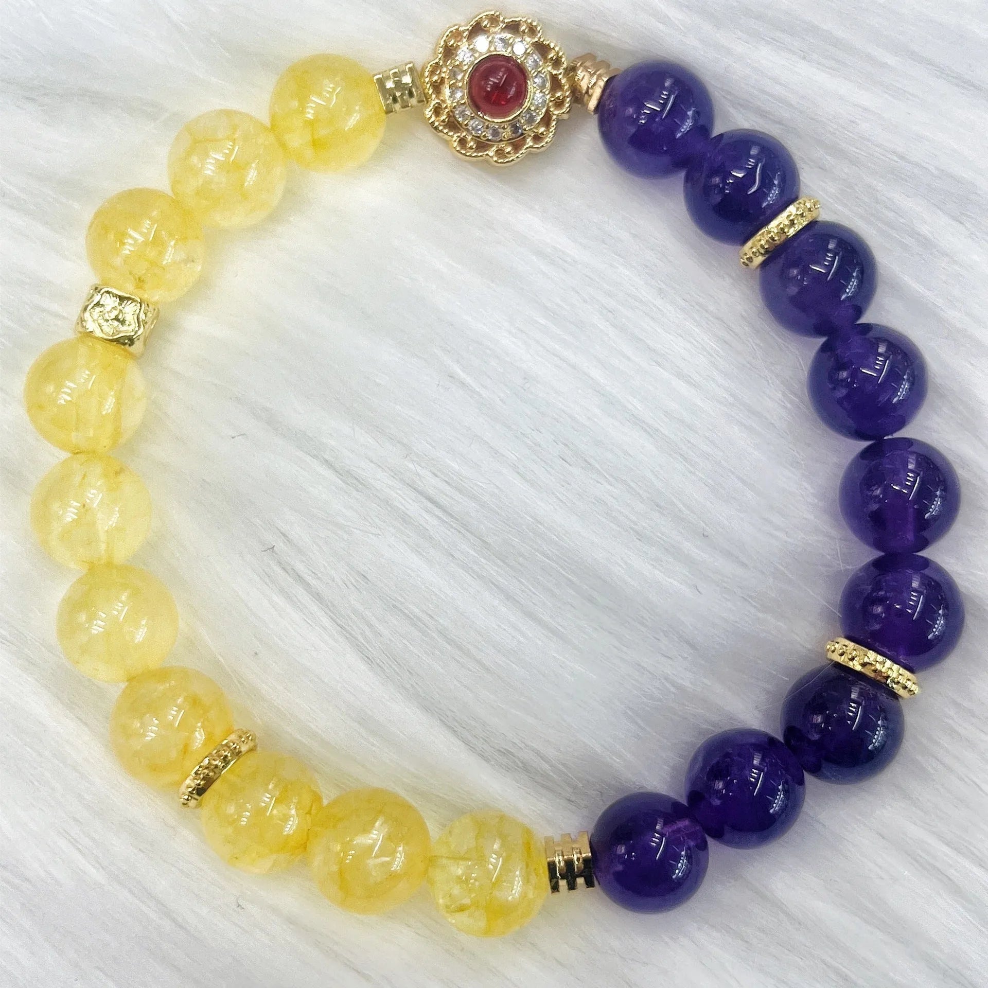 Handmade yellow and purple crystal women's bracelet on wrist.