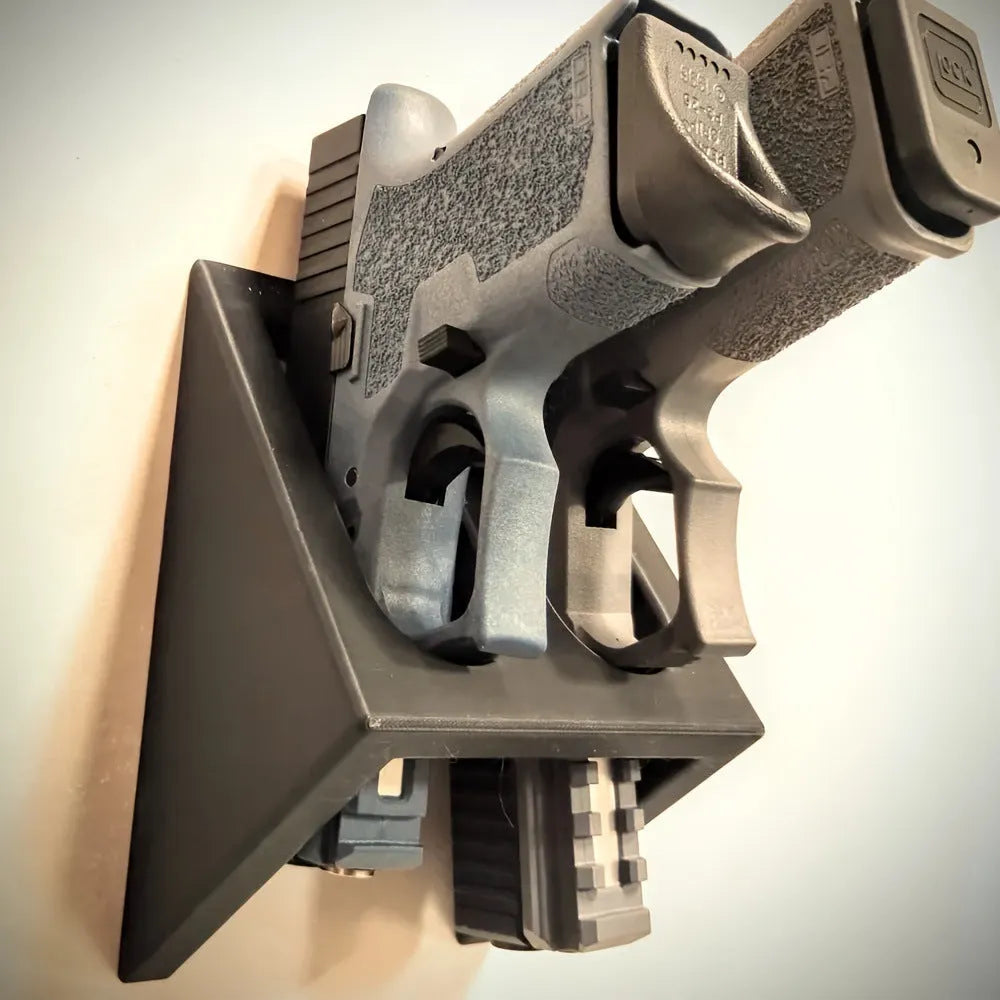 Black plastic pistol display stand for toy guns and cosplay accessories.