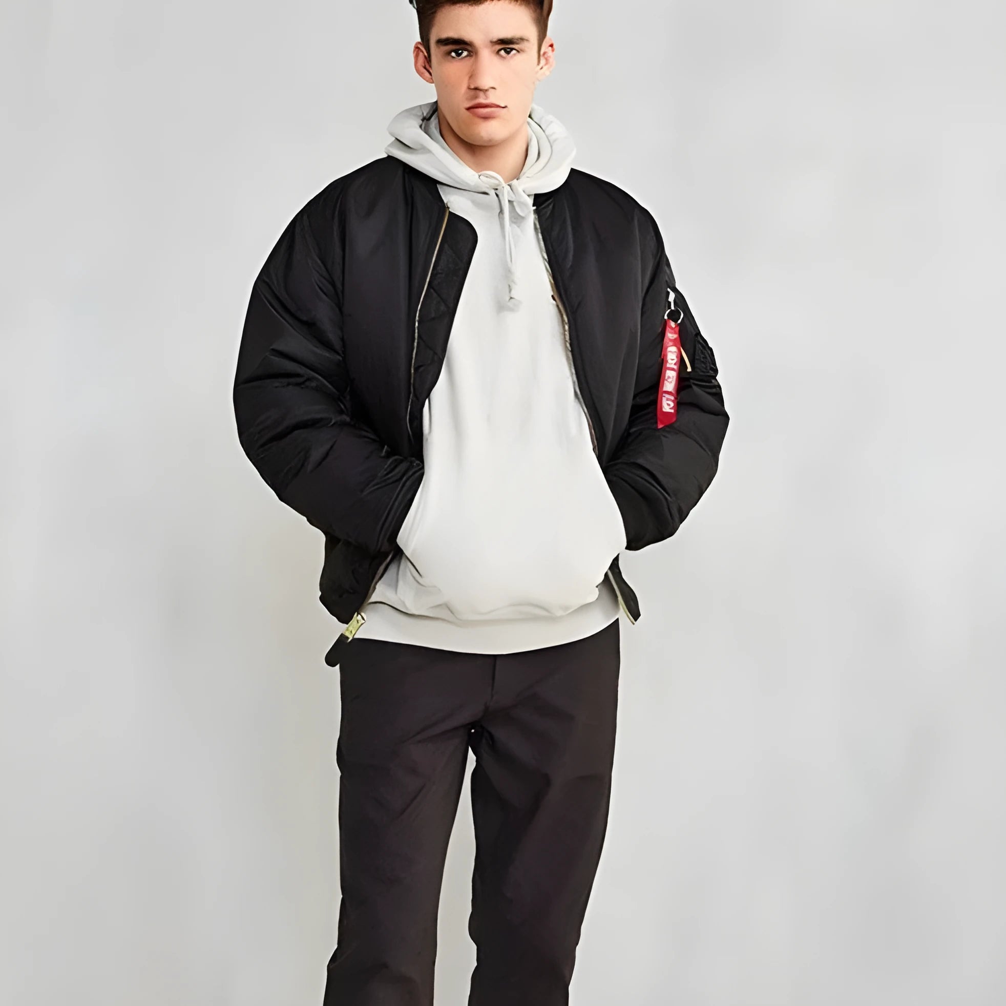 Men's loose-fit army green nylon pilot jacket on a hanger