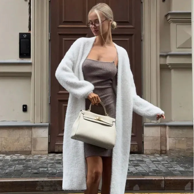 White knitted cardigan jacket with long sleeves and loose fit, shown as a versatile women's outerwear garment