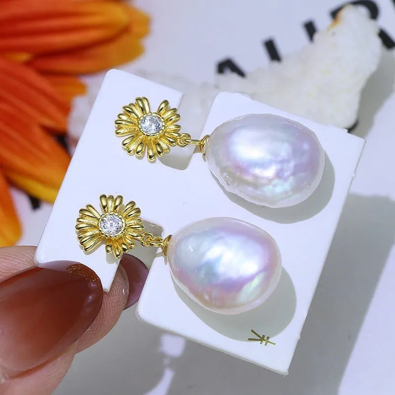 S925 sterling silver baroque flower design earrings and ring holder on a table.